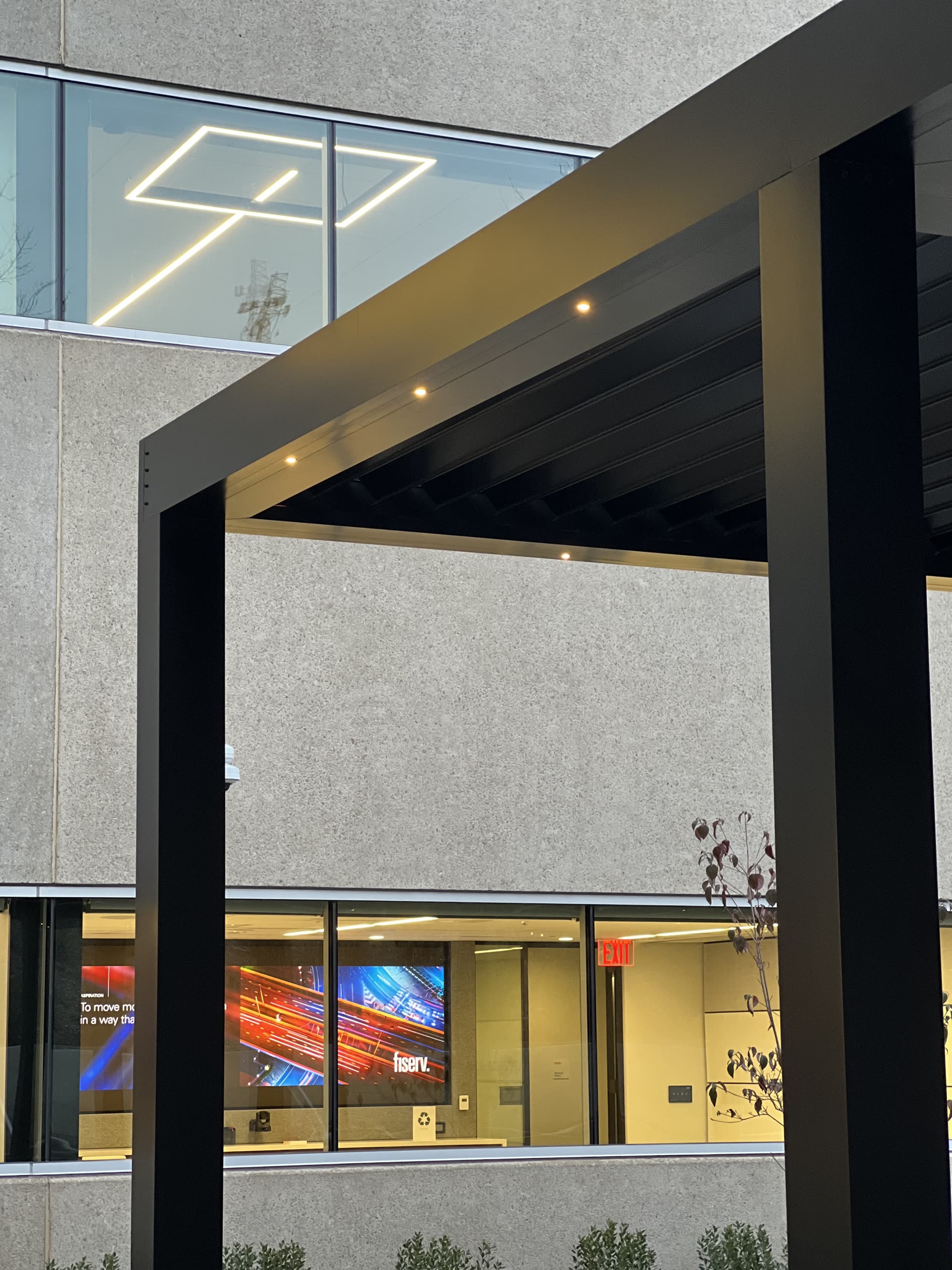 100 Connell Drive Berkeley Heights NJ — Breslow-installed black motorized louvered roof over the corporate campus entrance plaza