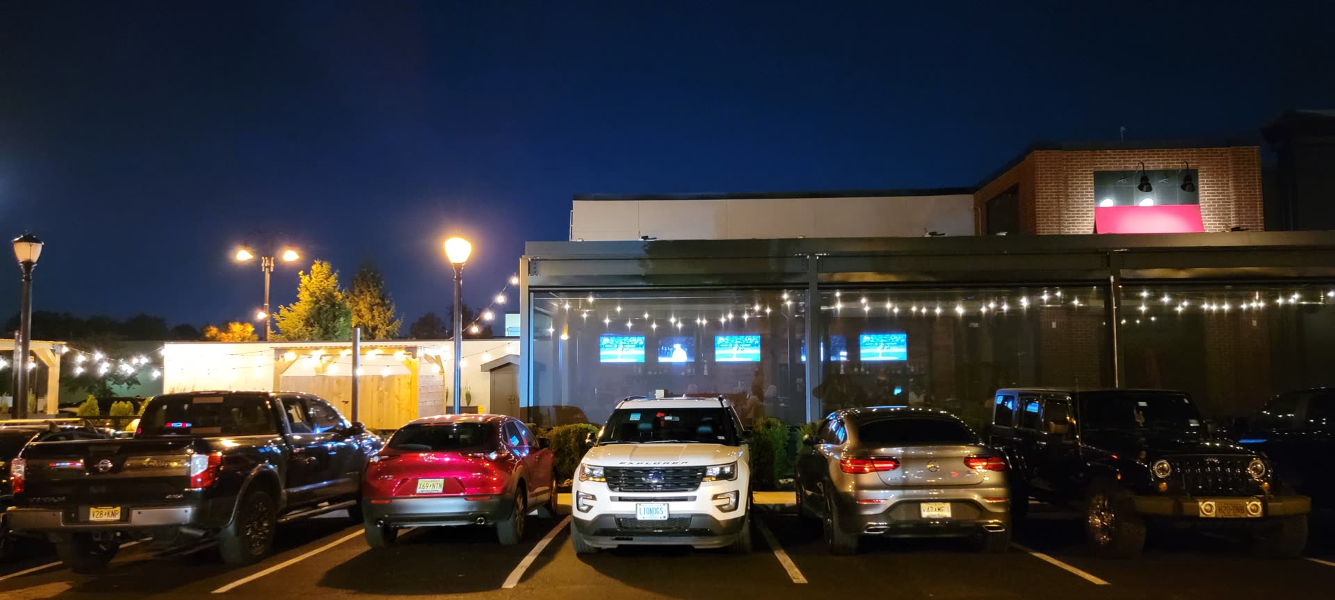 Tommy's Tavern + Tap Clifton NJ — Breslow-installed Azenco R-Blade motorized louvered roof at evening