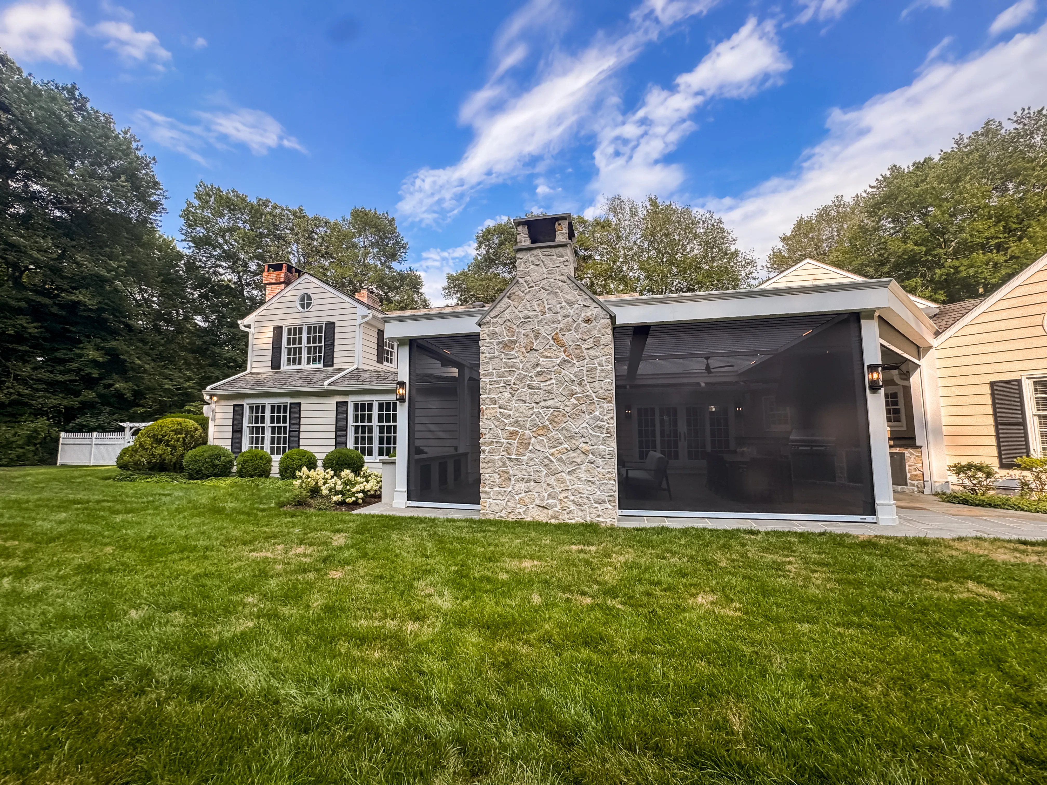 Custom pergola with concealed motorized retractable screens — Hambrook estate exterior wide view