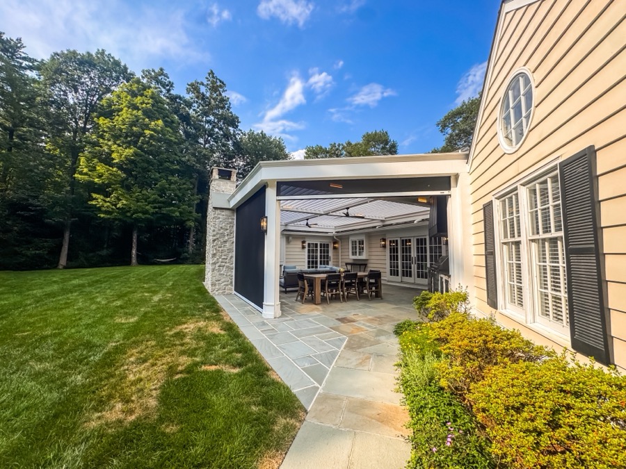 Motorized screen shades over a pavilion