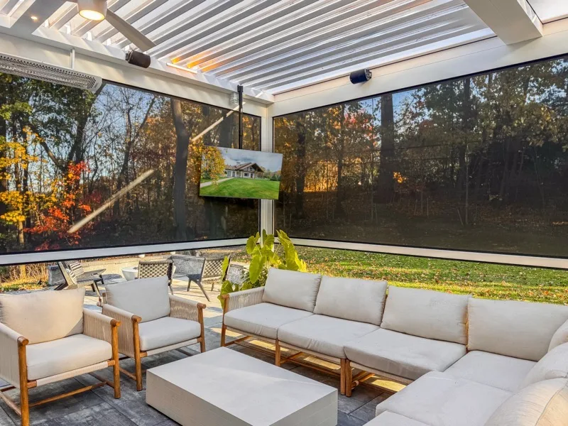 Modern louvered pergola with motorized screens and TV