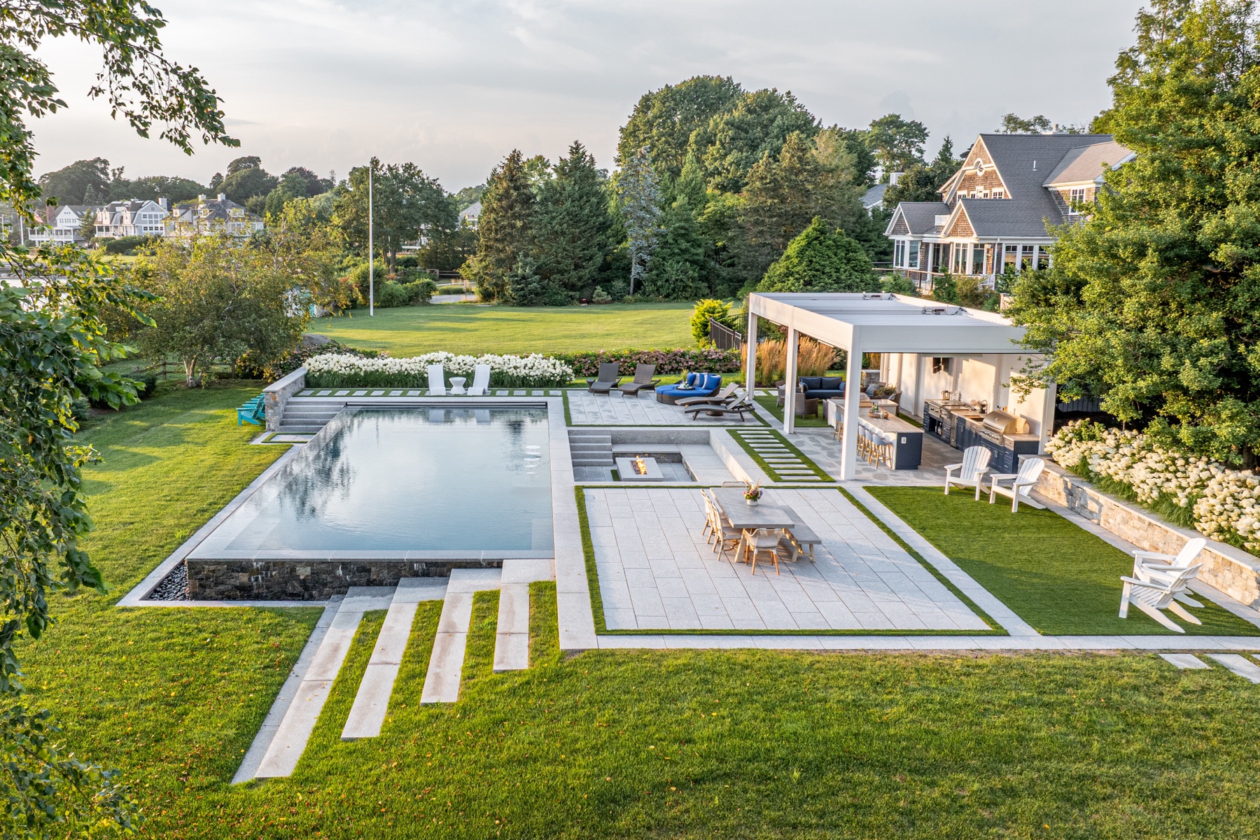Daytime aerial of the full outdoor living space and grounds